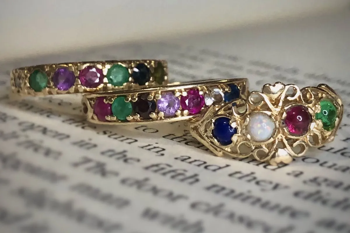 Gold rings set with coloured stones along the band